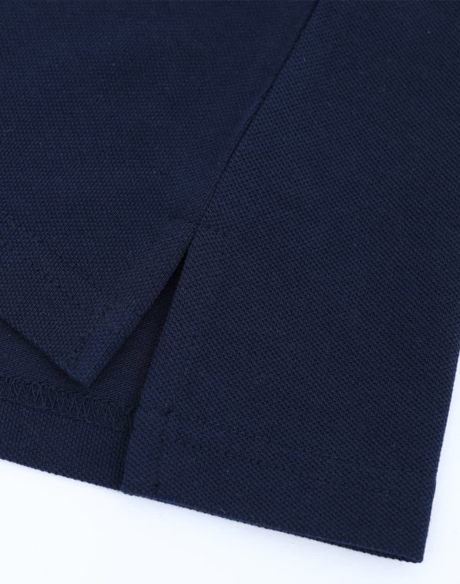 A navy blue ladies' classic cotton/poly pique short-sleeve polo featuring a side split detail. It has a logo.