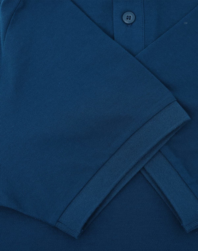 A men's ultrafine cotton pique polo in a deep navy blue, featuring a two-button placket and folded sleeves.