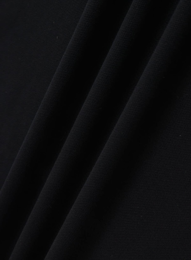 A black ultrafine cotton pique fabric, showcasing a smooth and textured surface. Features a logo or branding.