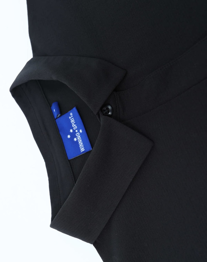A black polo shirt featuring a collar and a tag, showcasing a sleek, high-performance design.