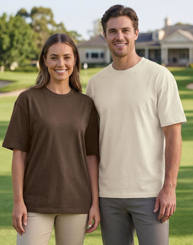A brown and a cream unisex heavy cotton oversized tee worn by two models in an outdoor setting.