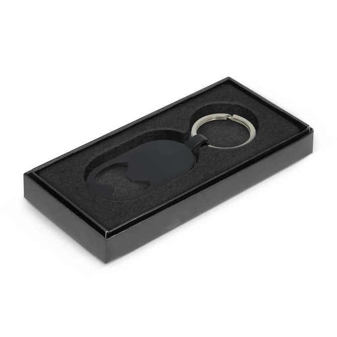 A drink bottle opener key ring in black, presented in a sleek black box with a foam insert.