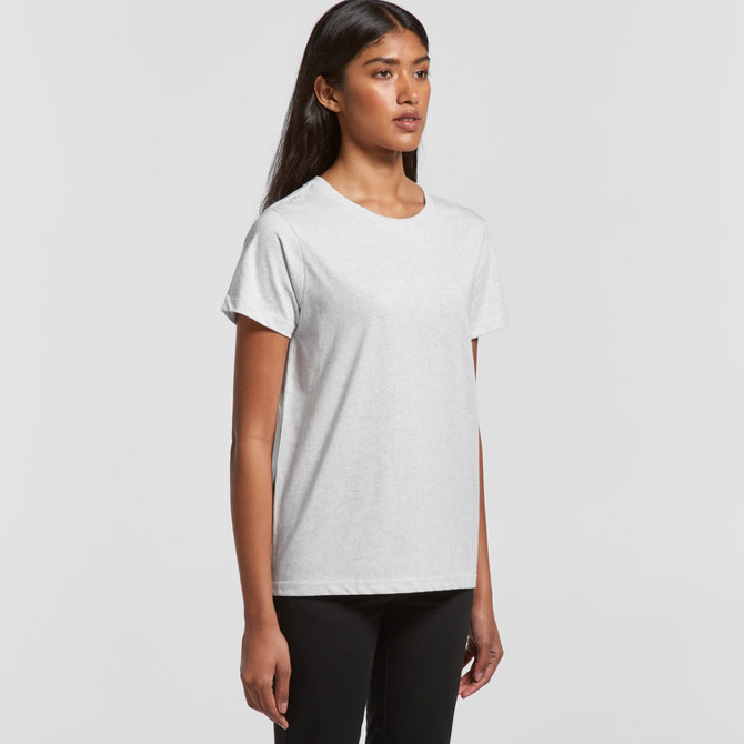 A model wearing a light grey t-shirt. The shirt features a simple design and has a logo.