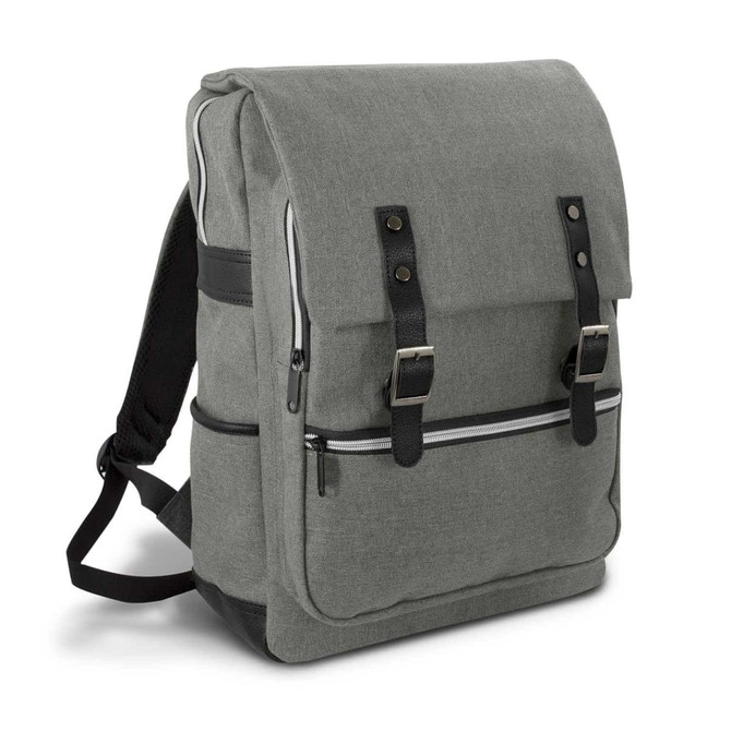 A grey backpack with a flap closure, zippers, and black accents, featuring straps and a branding logo.