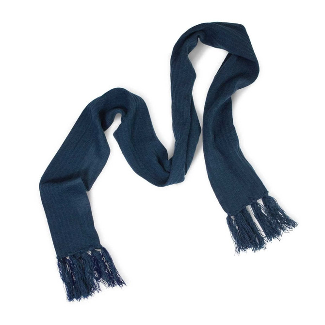 A Nebraska Cable Knit Scarf in a deep blue shade with fringed ends.