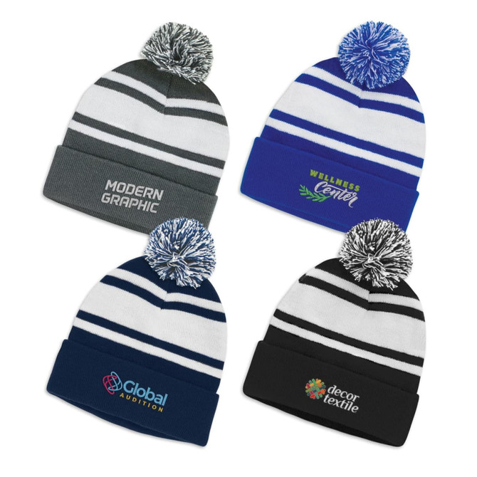 A collection of four beanies with pom poms, featuring different colour schemes and logos.