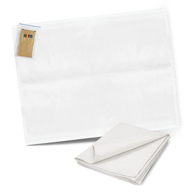 A white cotton tea towel with a folded corner, accompanied by a set of colouring pens.