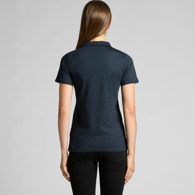 A navy polo shirt with a short collar and fitted design, viewed from the back on a model.
