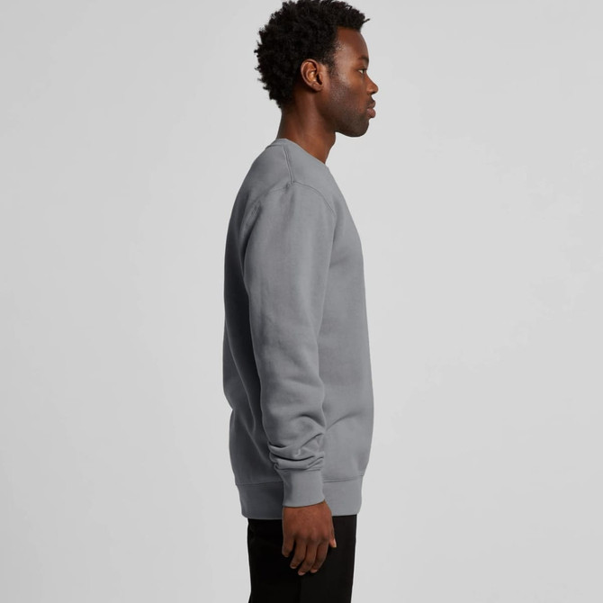A grey hoodie is displayed on a person facing to the side, featuring a simple design and long sleeves.