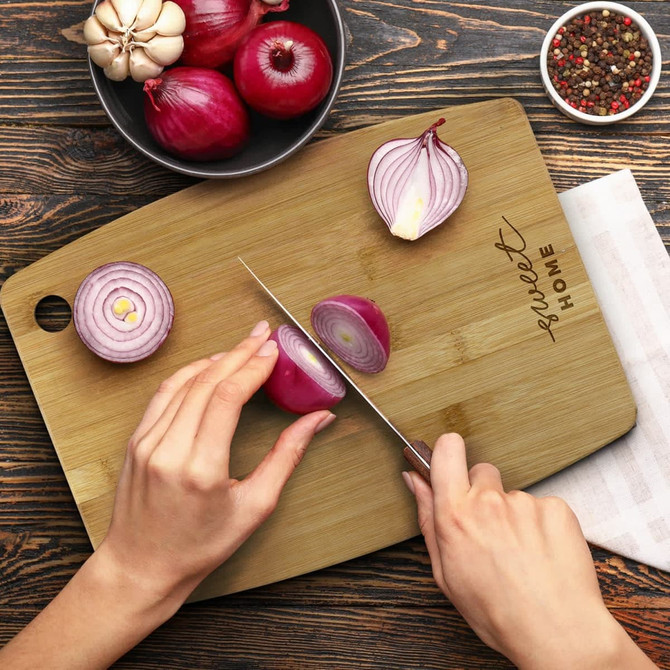 A bamboo chopping board in a light brown packaging with a simple design and logo.