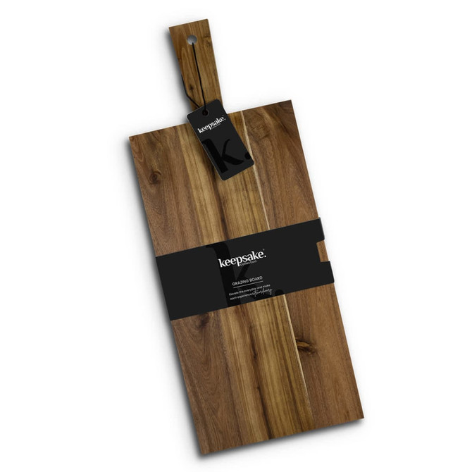 A wooden chopping board with a smooth finish, featuring a hang tag and a dark band around its centre.