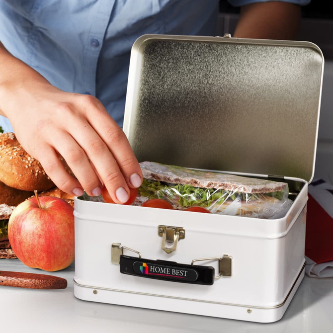 A white tin lunch box with a metal clasp, containing sandwiches and an apple, with a hand reaching in to grab food.