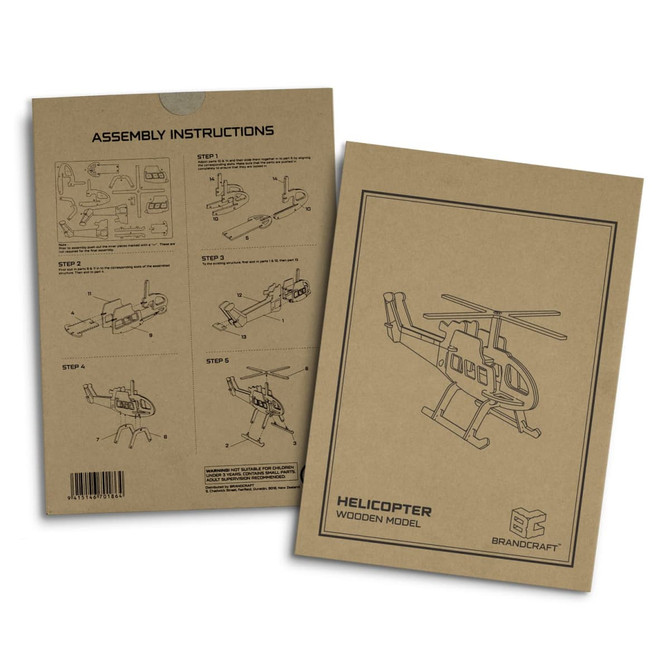 A beige instruction booklet featuring assembly steps for a wooden helicopter model, with illustrations and a logo.