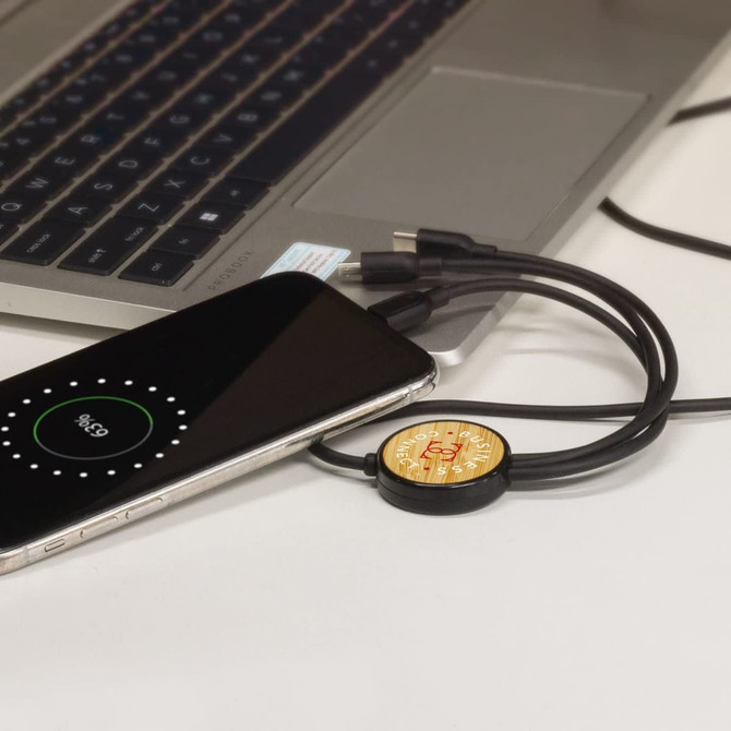 A bamboo triple connector charging cable in black, connected to a smartphone and a laptop.