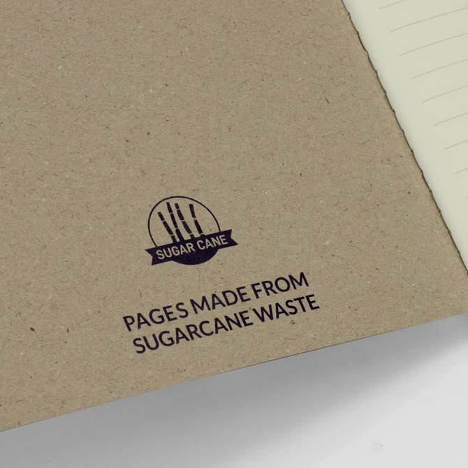 A sugarcane paper soft cover notebook with a brown cover and a logo, featuring eco-friendly pages made from sugarcane waste.