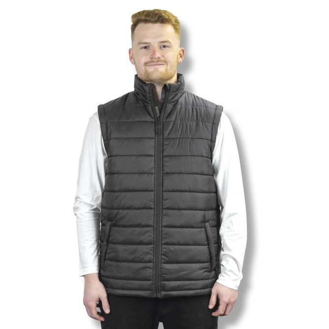 A unisex puffer vest in charcoal grey, featuring a high collar and a zipped front, worn by a model.