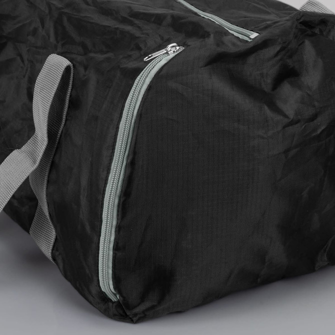 A black foldable duffle bag with grey handles and a zippered closure. It features a logo on the side.