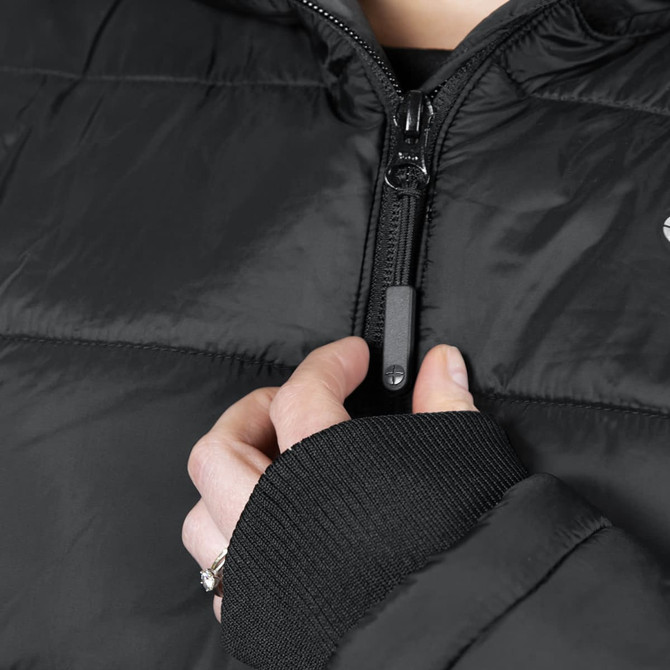 A black puffer jacket featuring a zip closure and ribbed cuffs, worn by a person adjusting the zipper with one hand.