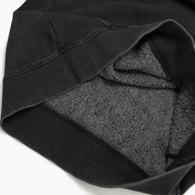 A black unisex hoodie with a soft, fleece-lined interior and ribbed cuffs, featuring a small logo.