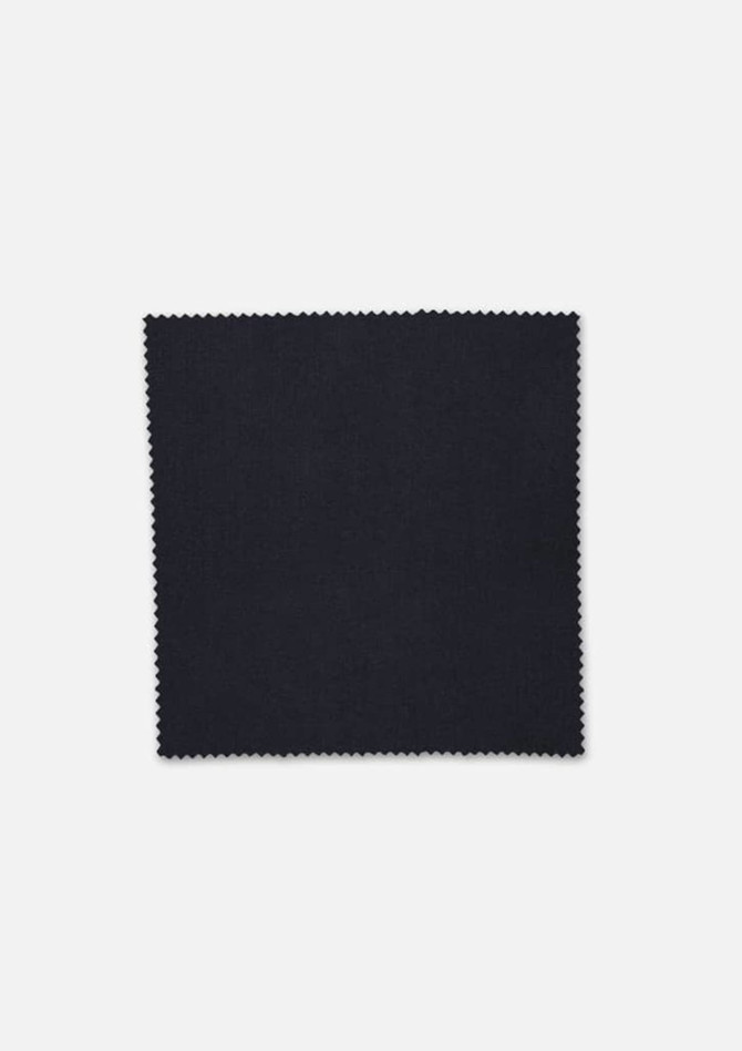 A square swatch of black fabric with a textured finish, edged with a zigzag pattern.