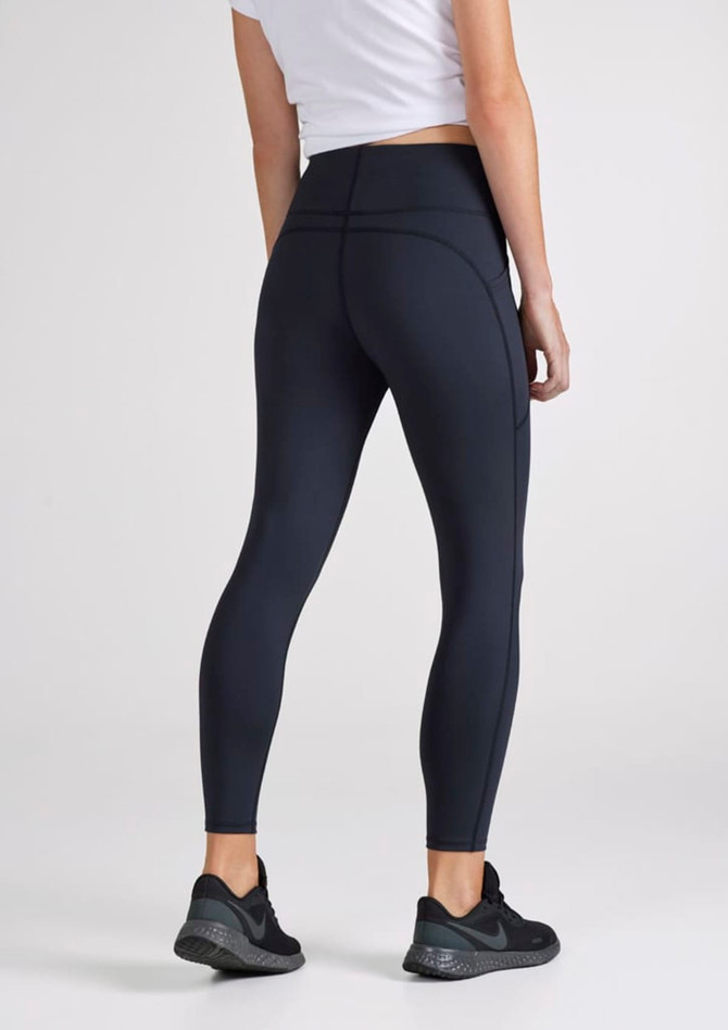 A pair of women's 7/8 length leggings in navy blue with a high waistband, featuring a logo.