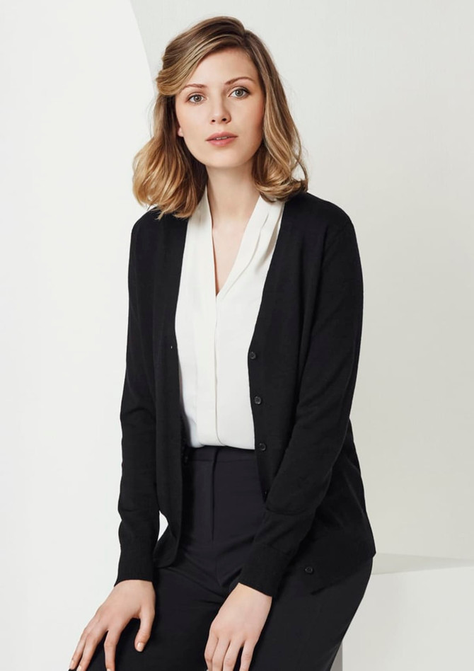 A black women's cardigan featuring a button front and a soft knit texture, worn over a white blouse and black trousers.