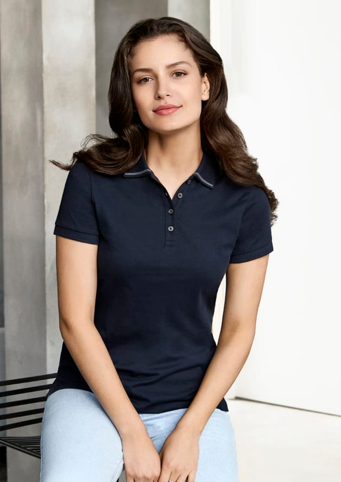 A navy women's polo shirt with short sleeves, featuring a collar and buttons, designed for casual wear.