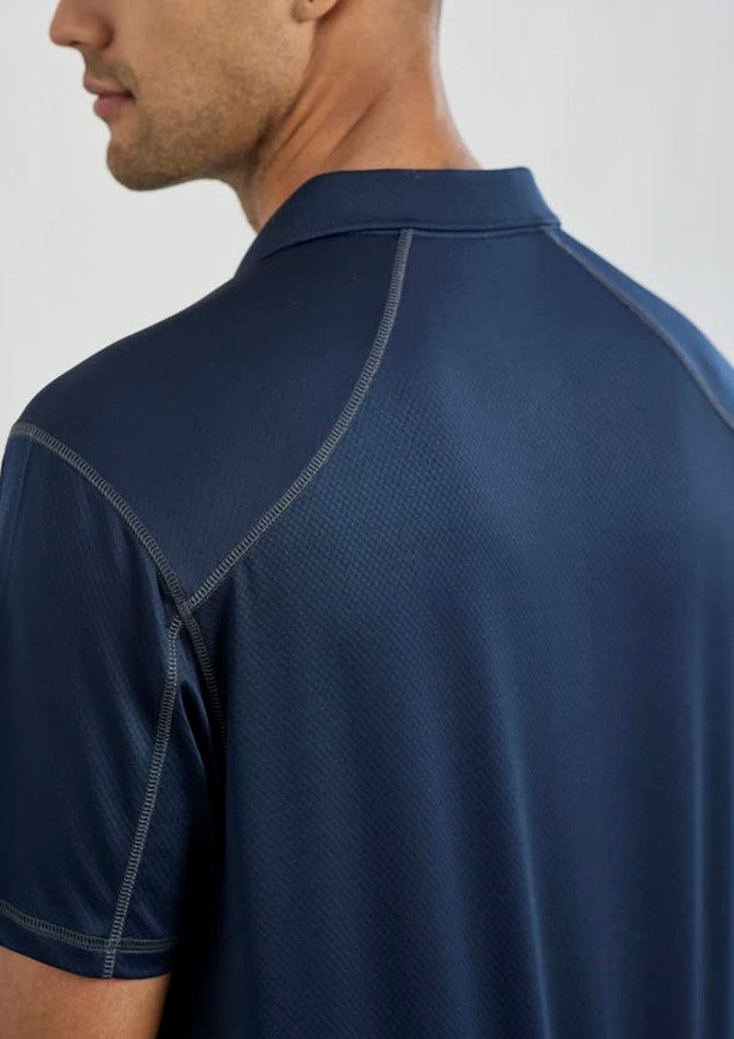 A men's short sleeve polo shirt in navy blue, featuring a subtle texture and a logo on the collar.