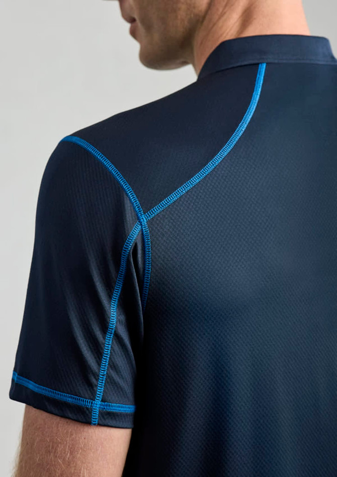 A men's short sleeve polo shirt in navy blue with contrasting blue stitching and a logo on the collar.