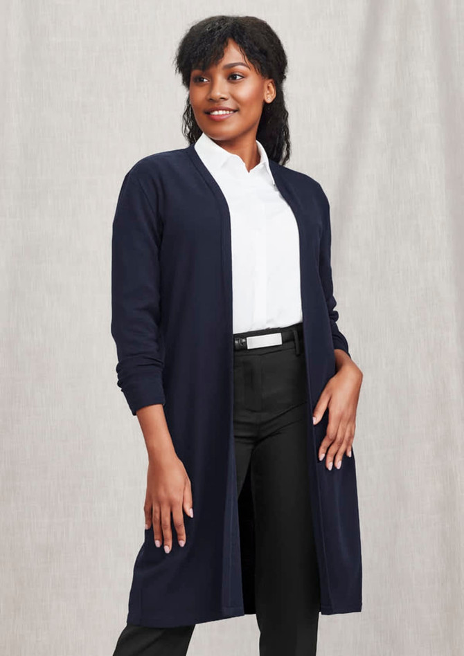 A navy longline cardigan with a clean, open front and long sleeves, paired with a white shirt and black pants.