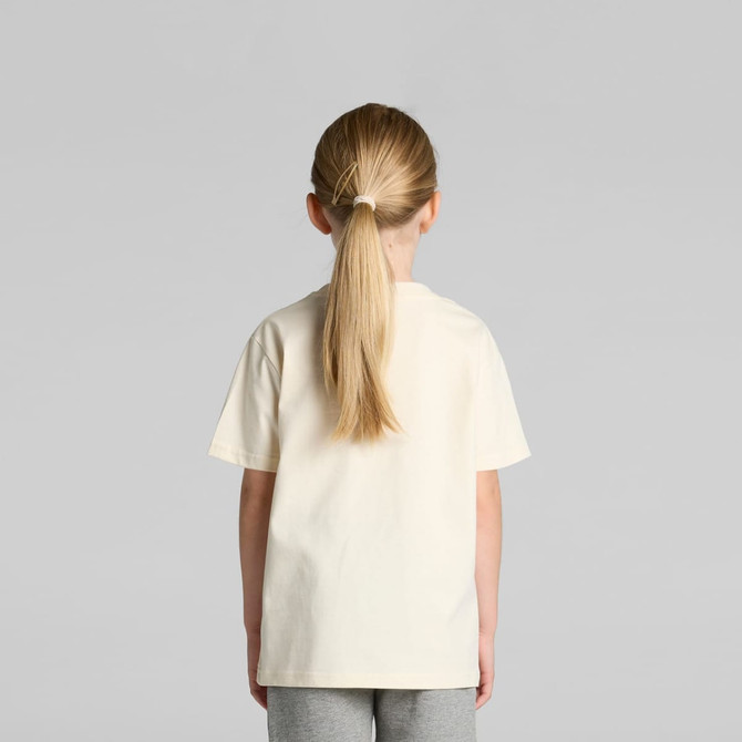 A kids' classic tee in cream, featuring a simple design and a loose fit, shown from the back on a child.