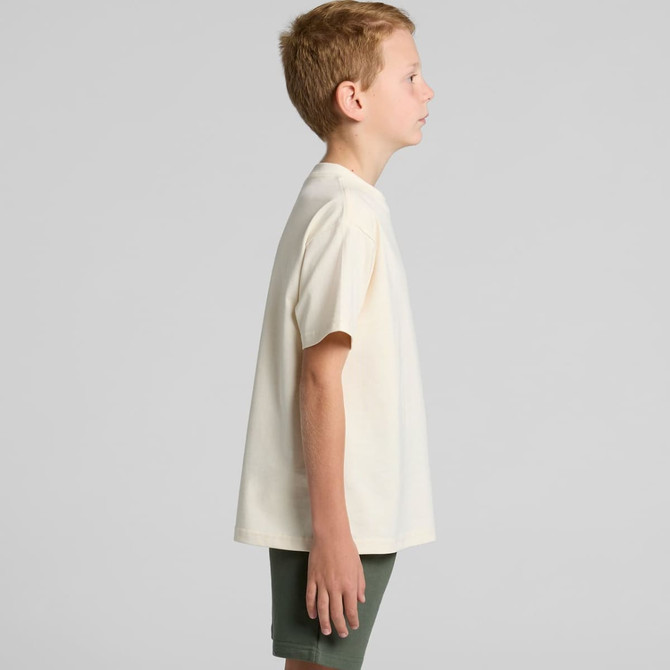 A plain cream youth t-shirt displayed from the side, featuring short sleeves and a comfortable fit.