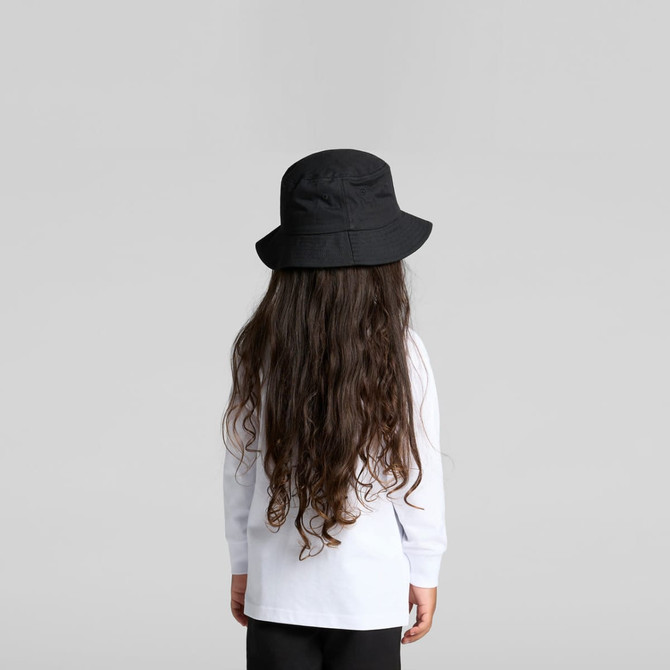 A child wearing a long-sleeve white T-shirt and a black bucket hat, facing away from the camera.