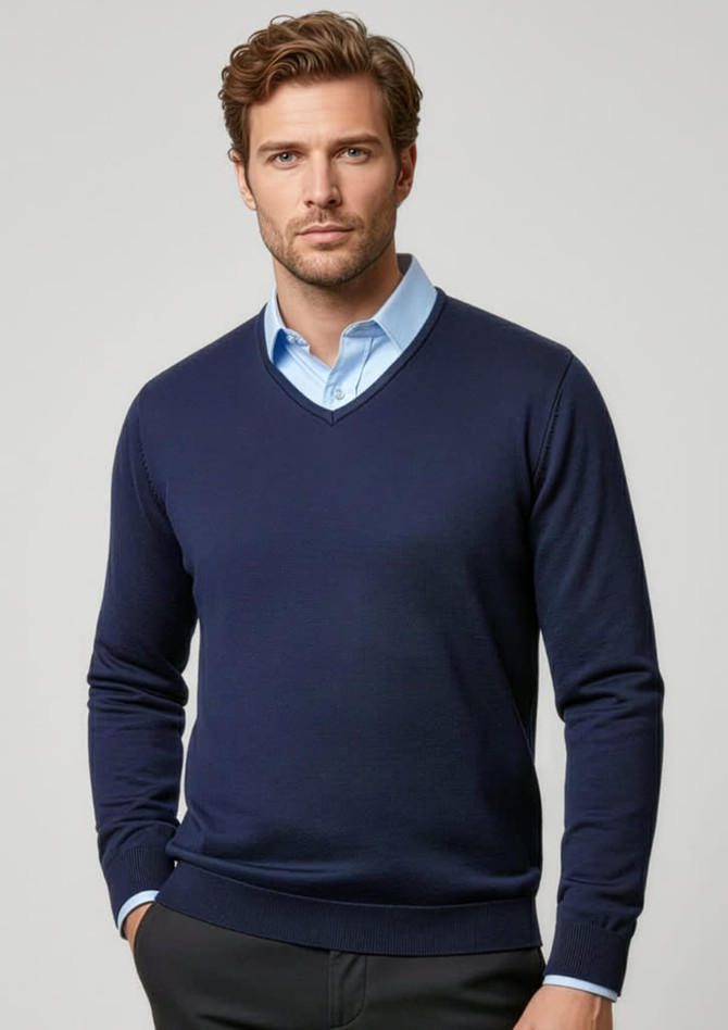 A navy men's pullover sweater with a V-neck design, worn over a light blue collared shirt. Features a logo.