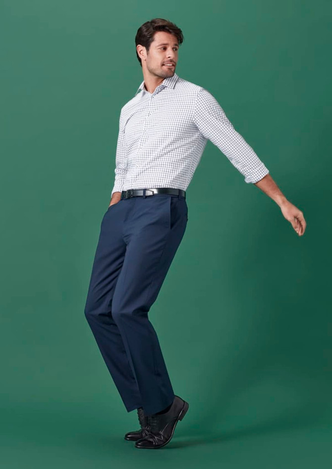 Men's straight leg slacks in navy blue, paired with a checked shirt, against a green background.