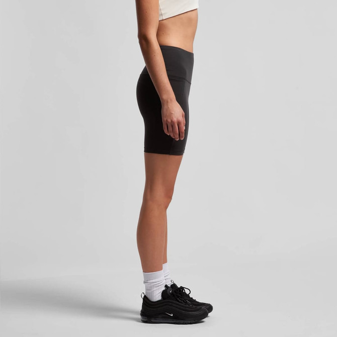 Active bike shorts in black, featuring a fitted design and a high waistband, paired with black trainers.