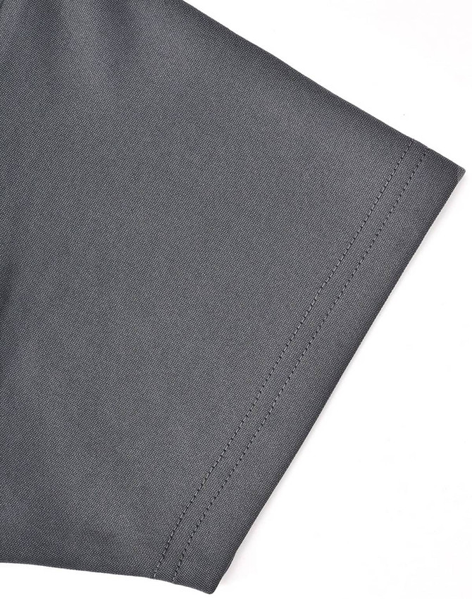 A close-up of the sleeve of a grey polo shirt, featuring a stitching detail and a logo on the fabric.