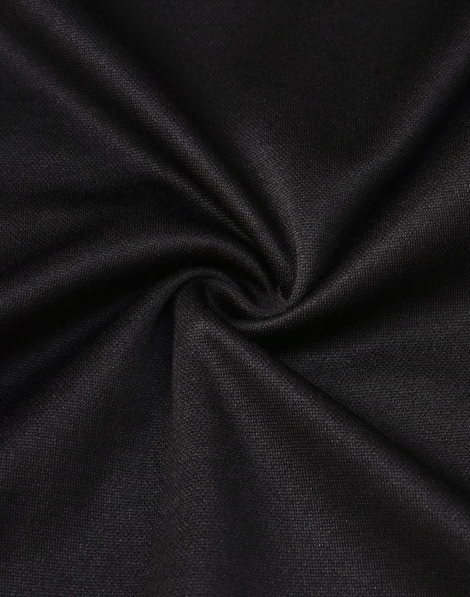 A close-up of black sustainable poly/cotton fabric, showing its smooth texture and stretch ability.