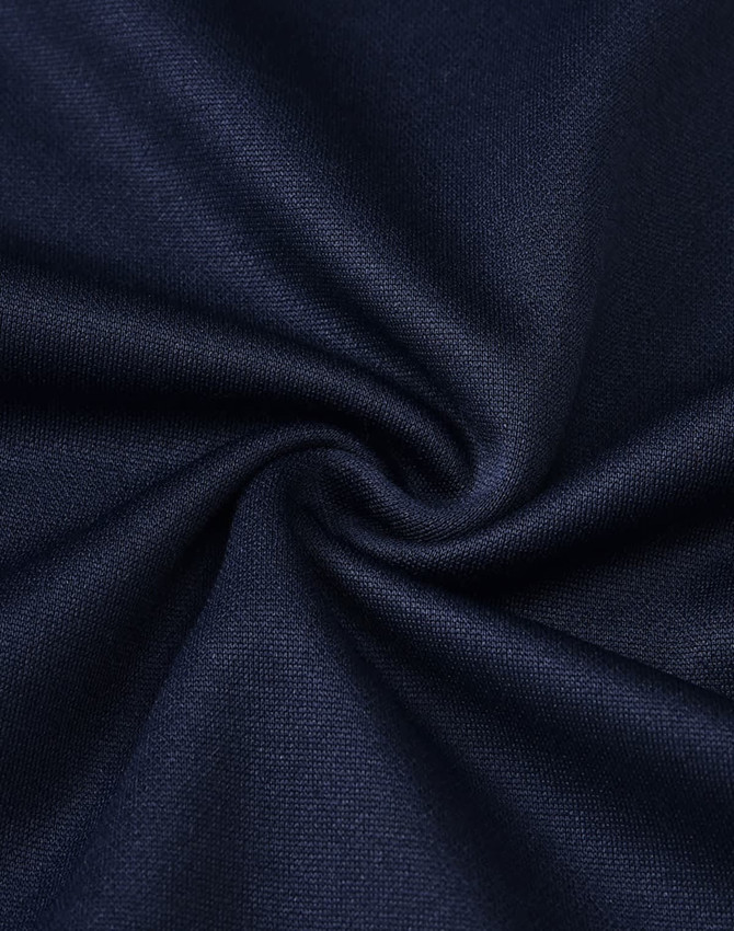 A close-up of dark navy fabric, showcasing a smooth polyester and cotton blend with a subtle texture.