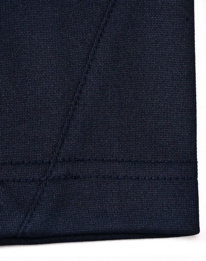A navy blue polo shirt featuring a contrast collar, made from sustainable poly/cotton fabric.