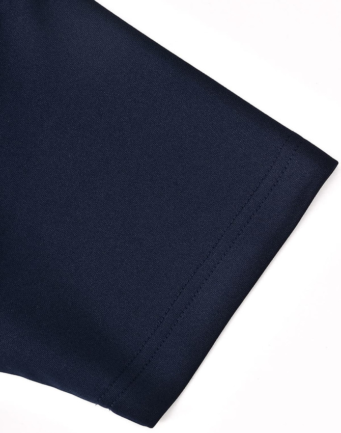 A close-up of a navy polo shirt sleeve, showcasing the fabric and stitching detail. The shirt has a logo.