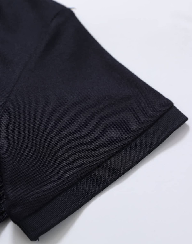 A close-up of the sleeve of a black Ladies' Truedry Pique Polo shirt, featuring a simple design and a brand logo.