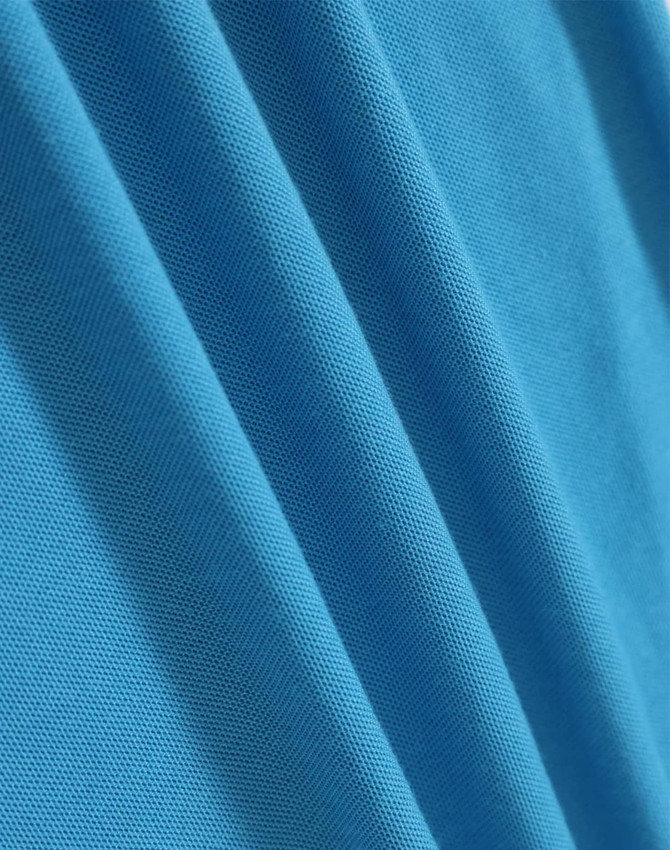 A close-up of smooth, vibrant blue fabric, showcasing the texture and quality of the material.