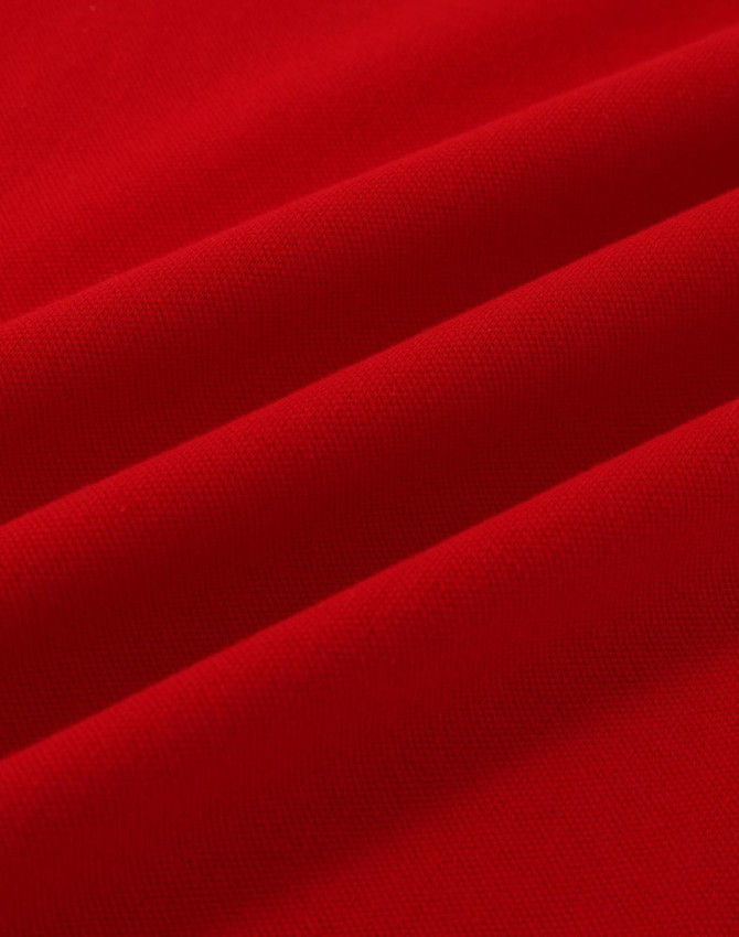 A vibrant red cotton stretch fabric with soft folds, suitable for polo shirts. Features a logo.