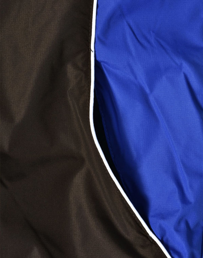 A unisex jacket featuring a combination of black and blue fabric with contrasting white lining.