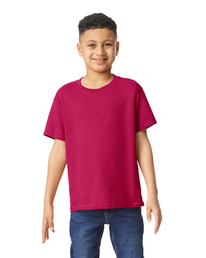 A youth T-shirt in bright magenta, featuring a simple design and a logo on the chest, worn by a smiling child.