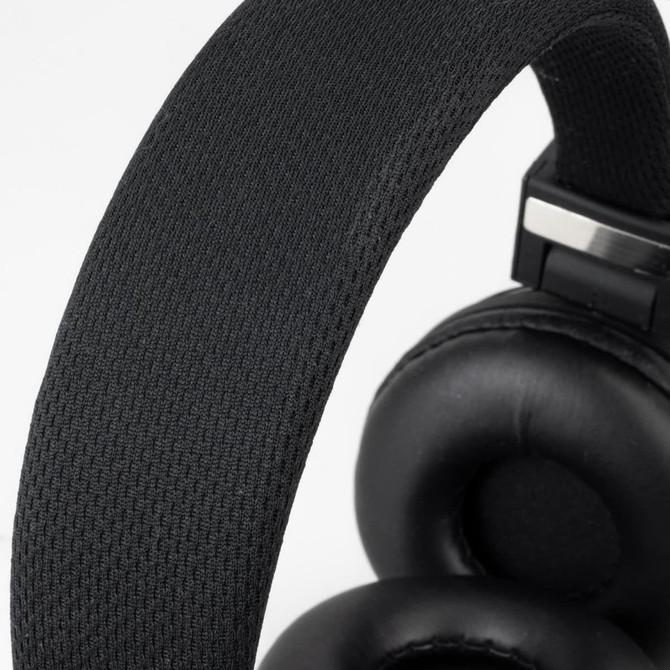 Black Bluetooth headphones with a textured headband and cushioned ear cups. Features branding on the side.