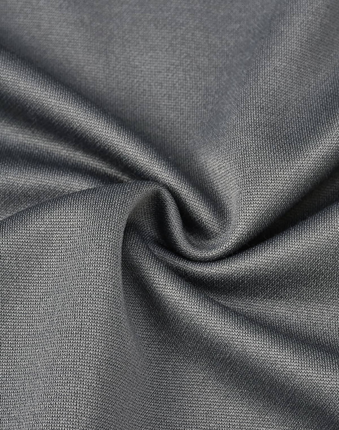 A close-up of grey sustainable poly/cotton fabric, showing its smooth texture and weave pattern.