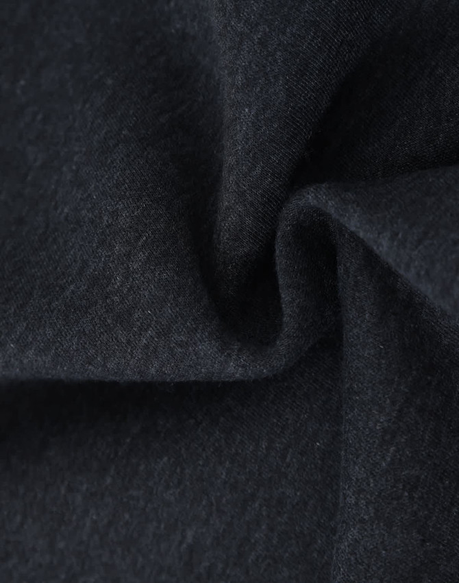 A close-up of dark grey fabric, showcasing a soft and textured fleece material suitable for jumpers.