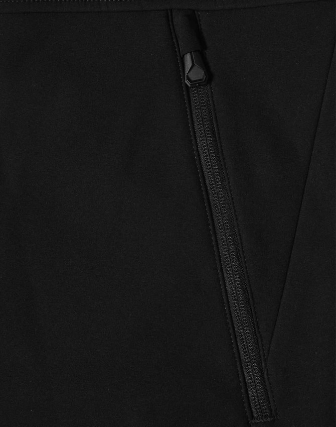 A black softshell hi-tech vest featuring a zippered pocket and a sleek design. It has a logo on the fabric.